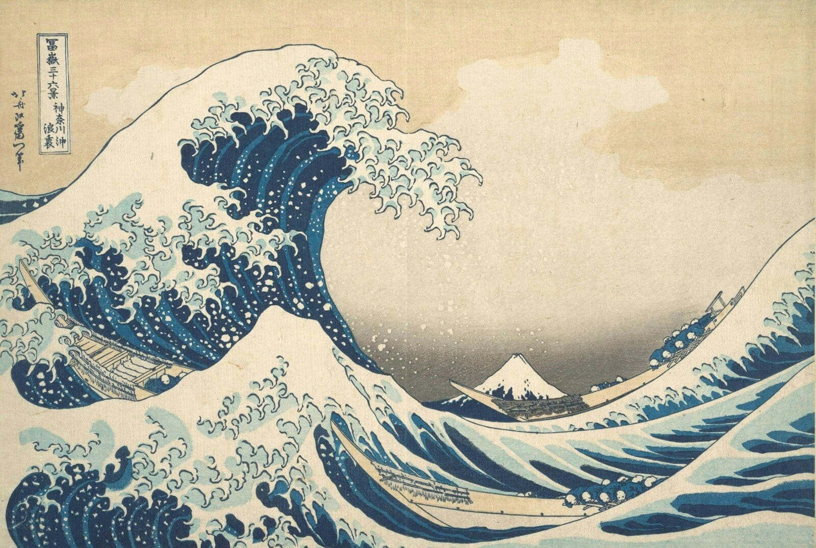 A large blue wave cresting over boats near Mount Fuji in Japan